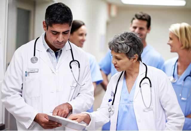 two doctors chat in hallway