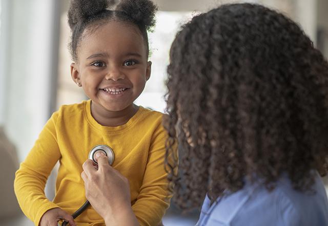 doctor listening to girl's chest - pediatric and congenital heart center