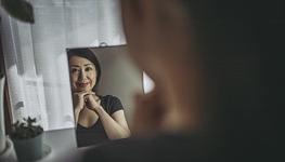 woman looking in mirror