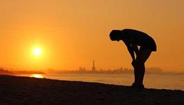 tired runner along sunset