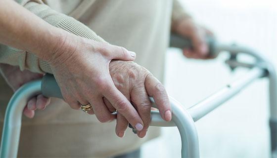 hands using a walker with help