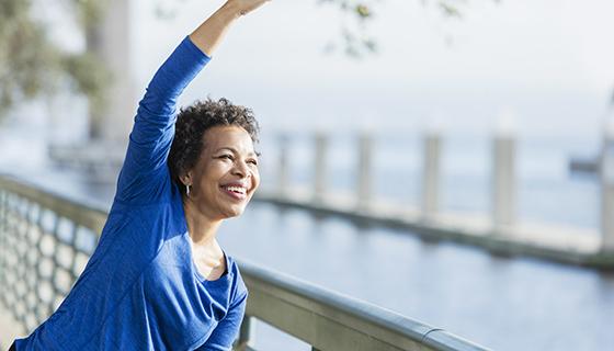 A woman stretches during her walk.