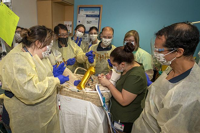 Ezra and his mom Olivia celebrate his first birthday with the care team in the NICU.