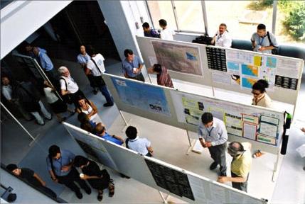 Attendees look at posters