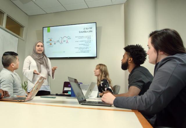 Student giving a presentation to other students