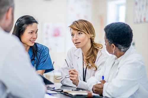 Group of care providers discussing patient