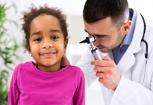 doctor checking girls ear