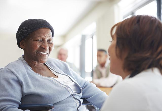 Elderly woman with caregiver