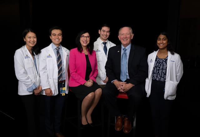 Those honored at the 2024 Scholarship Recognition Event are posing with smiles in front of a black background.